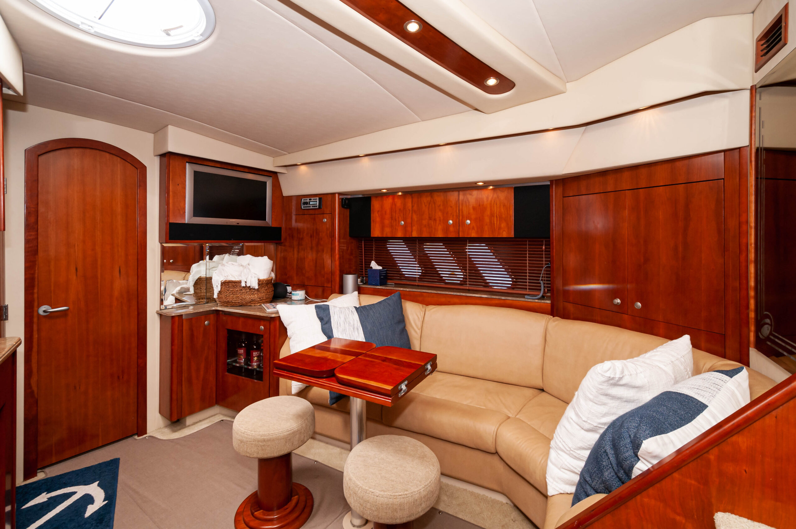 The Miss B Haven salon with curved seating, wood cabinetry, and a dining table