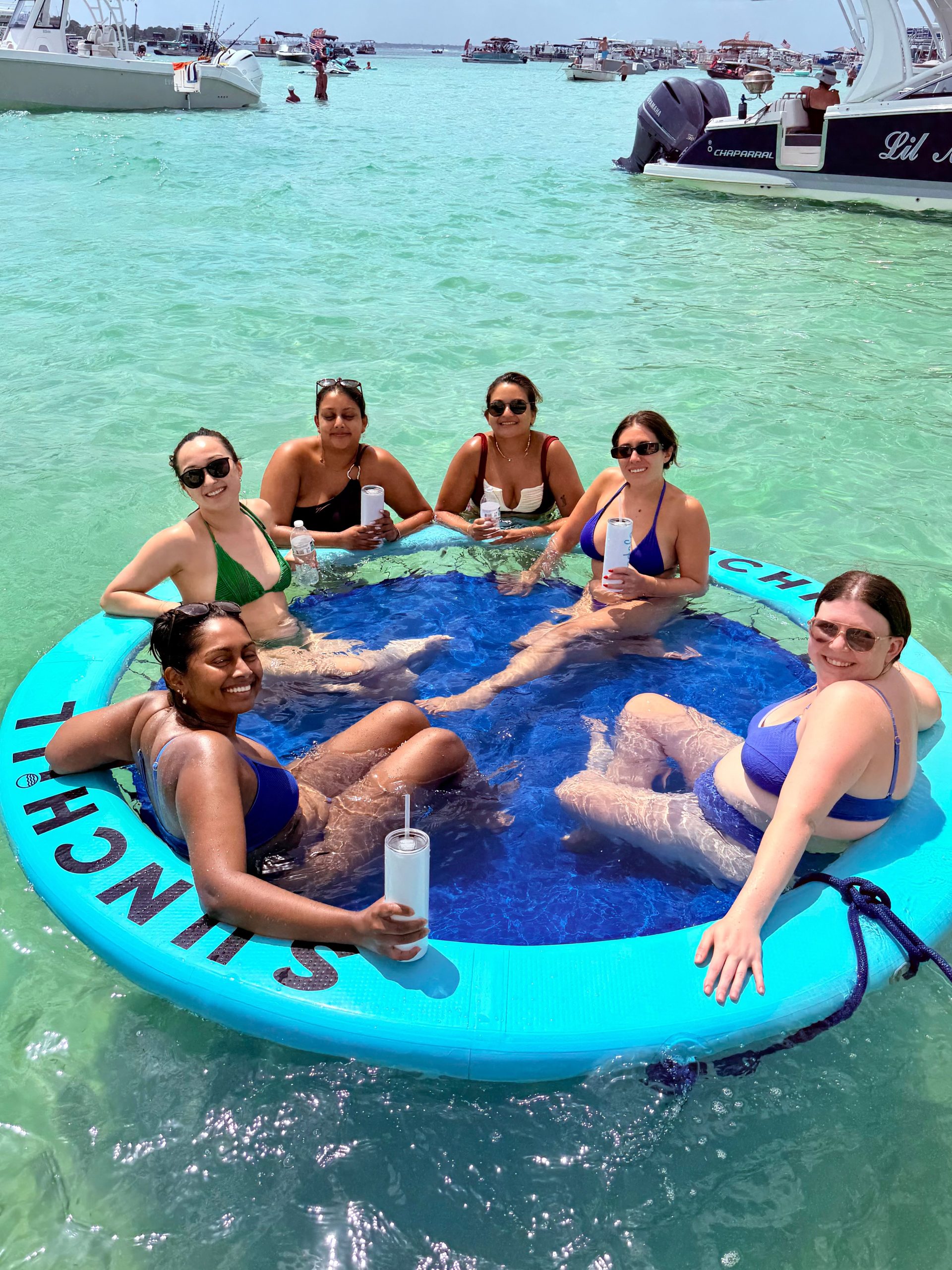 Bachelorette group relaxing on the Sunchill floating raft in turquoise water