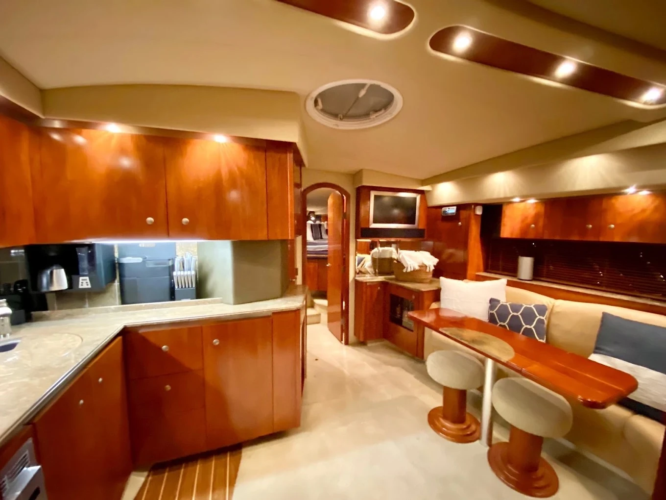 The Miss B Haven galley and salon with wood cabinetry and seating